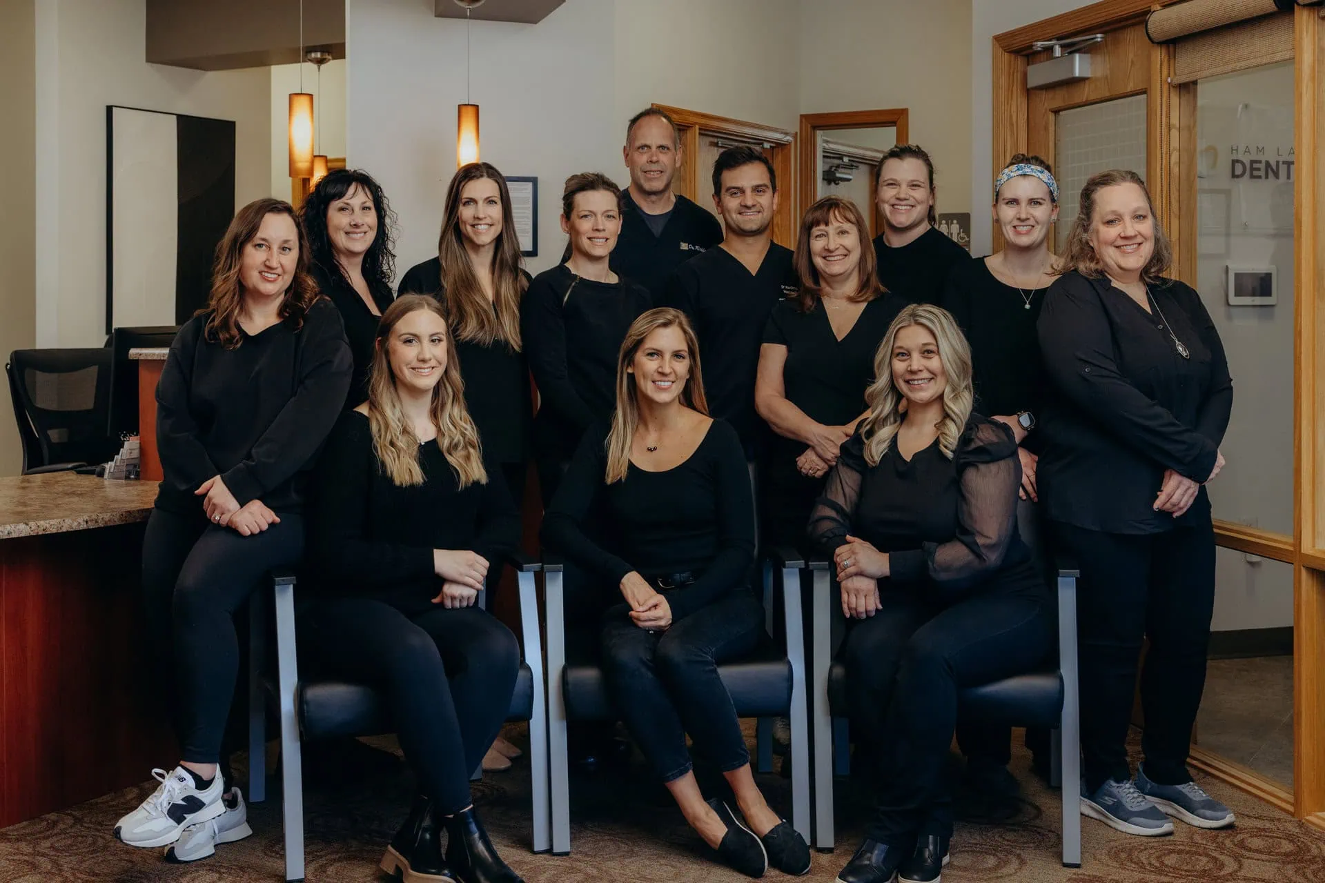 The Ham Lake Dental team seated and standing together in the office
